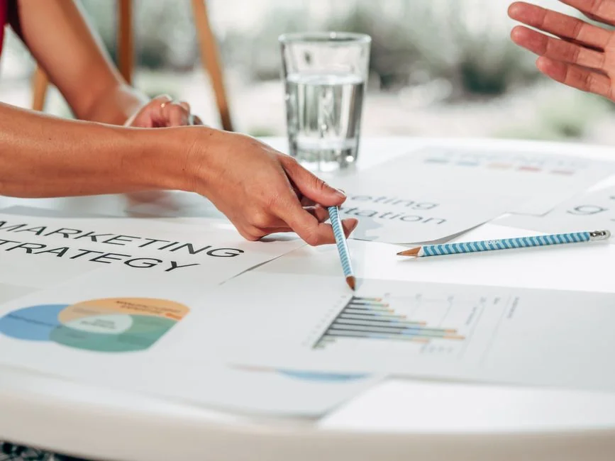 Close-up of SEO strategy planner with colorful sticky notes and a pencil on a notebook.